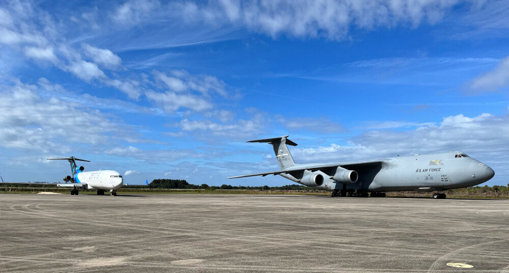 A C-5 Galaxy and the Zero Gravity Boeing 727 are next to each other at an airport. These airplanes are two of the main aircraft that Dianna Klein has flown in her career.