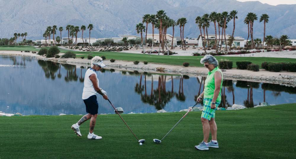 Abingdon Co. Image displays Jan Anderson and wife of 30+ years, Kore Grate, playing a round of golf in Palm Springs before attending the National Gay Pilots Association annual expo.