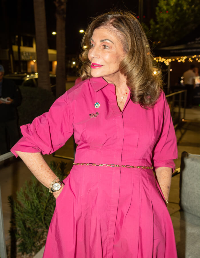 Las Vegas Mayor Shelley Berkley, an 74 year old elegant woman with brown hair in a pink dress standing outdoors at night.