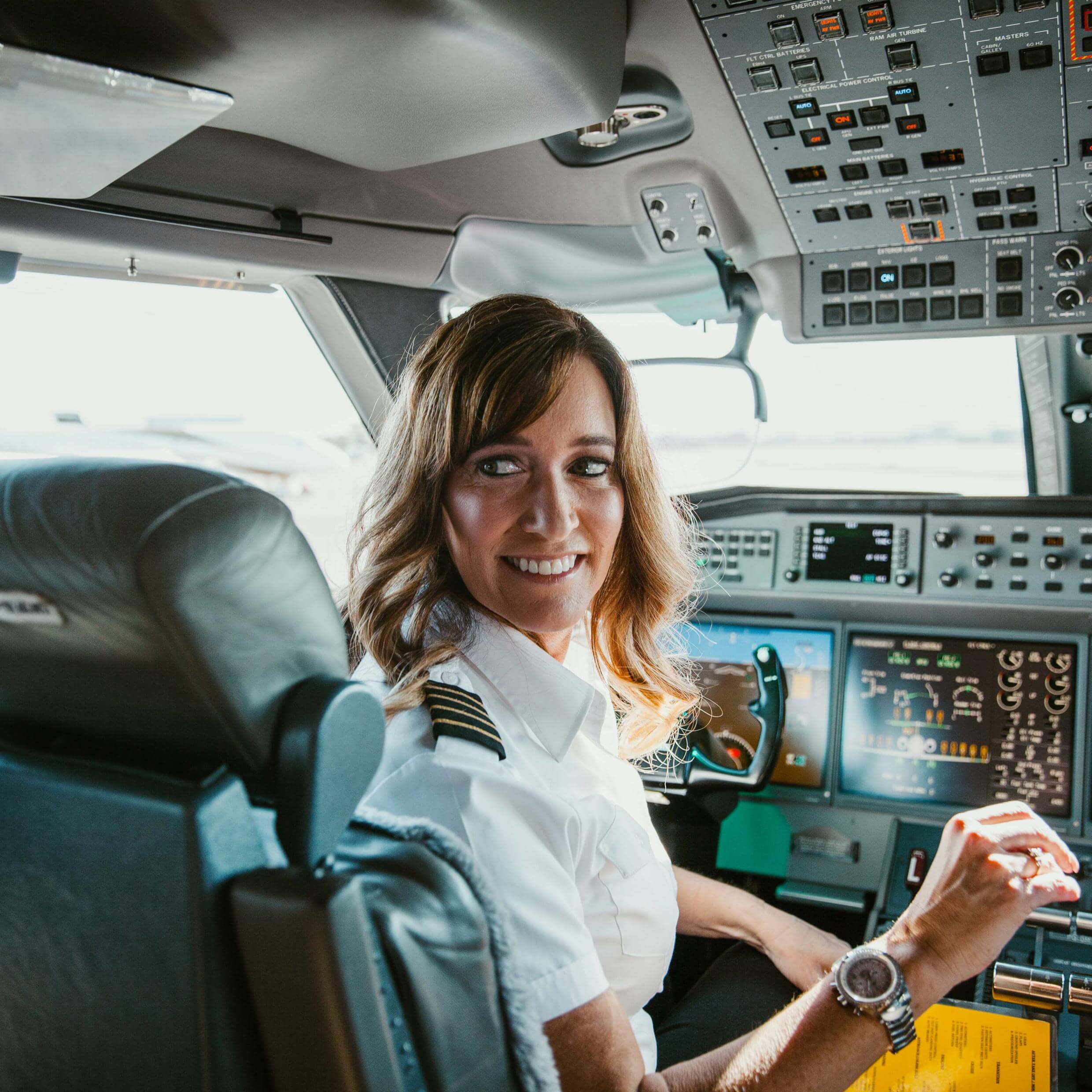 Abingdon Co. Image displays Female pilot in the flight deck wearing her Abingdon watch looking to the back of the aircraft.