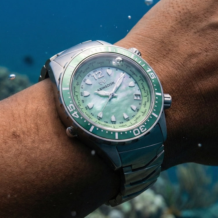 Abingdon Co Green and titanium Marina watch on a wrist with an underwater background
